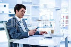Asian businessman using his phone