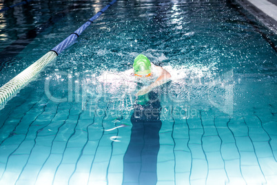 Fit woman swimming with swimming hat