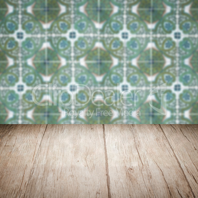 Wood table top and blur vintage ceramic tile pattern wall