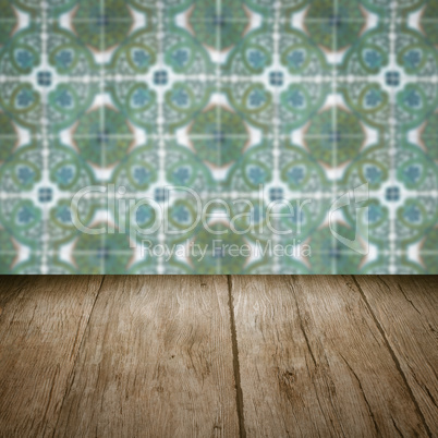 Wood table top and blur vintage ceramic tile pattern wall Wood table top and blur vintage ceramic tile pattern wall