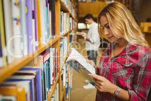 Attractive female student reading book