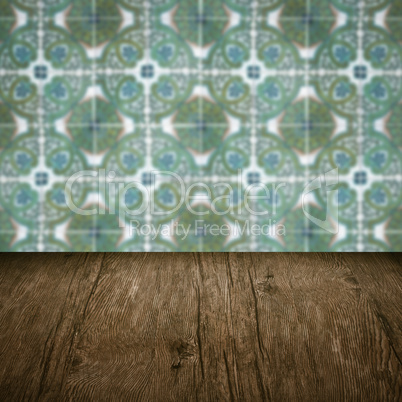 Wood table top and blur vintage ceramic tile pattern wall