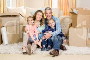 Portrait of smiling family sitting on the carpet