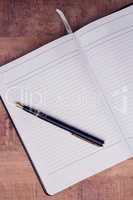 High angle view of pen on open book