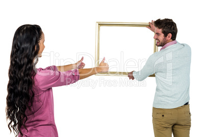Smiling couple with picture frame