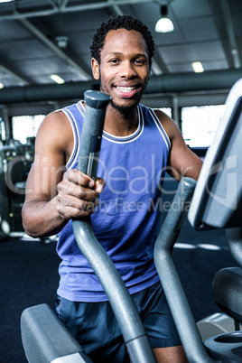 Smiling man working out on the machine