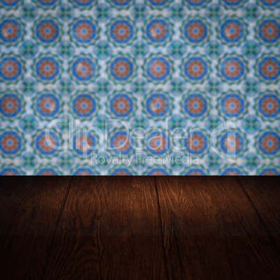 Wood table top and blur vintage ceramic tile pattern wall