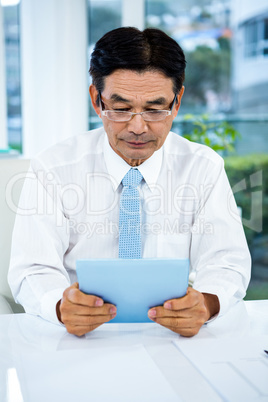 Businessman using his tablet