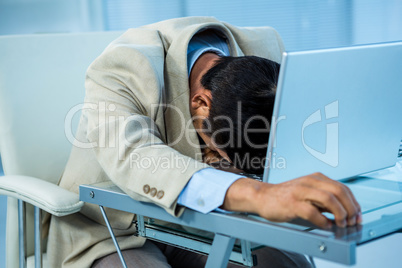 Tired asian businessman sleeping