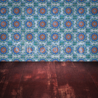 Wood table top and blur vintage ceramic tile pattern wall