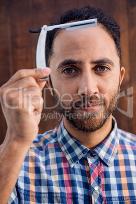 Portrait of businessman holding razor
