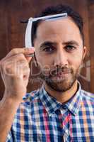 Portrait of businessman holding razor