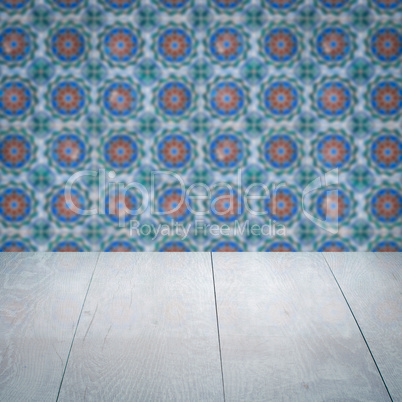 Wood table top and blur vintage ceramic tile pattern wall