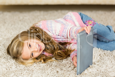 Happy girl lying on the floor