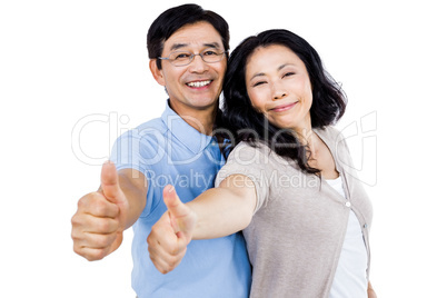 Couple standing together with thumbs up