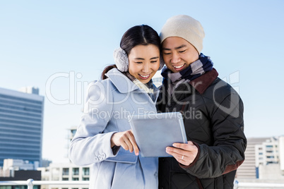 Happy couple using tablet computer