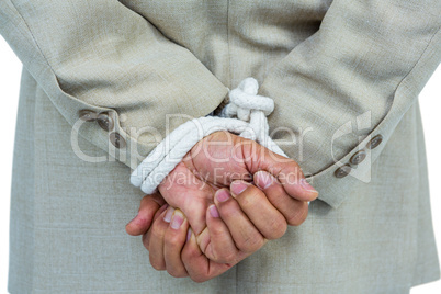 Businessman tied up in rope