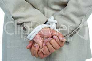 Businessman tied up in rope