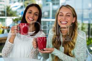 two girls drink tea