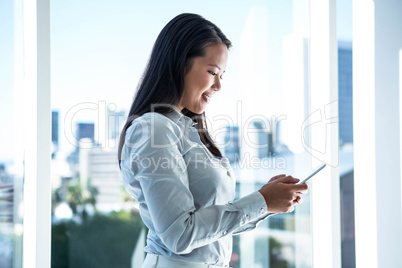 Smiling businesswoman using smartphone