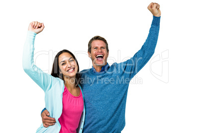 Successful couple with hands raised