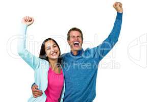 Successful couple with hands raised