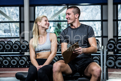 Fit woman discussing performance with trainer