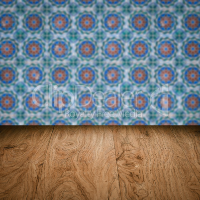 Wood table top and blur vintage ceramic tile pattern wall