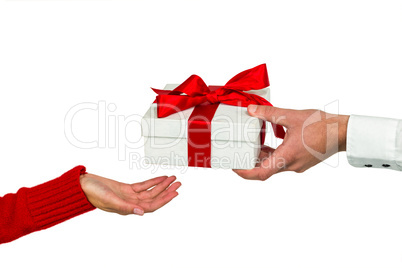 Cropped hand of man giving gift to woman