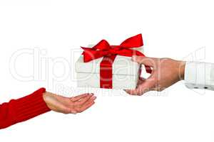 Cropped hand of man giving gift to woman