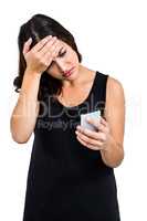 Depressed woman holding phone