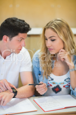 Two students timing their work