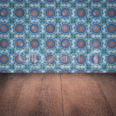 Wood table top and blur vintage ceramic tile pattern wall