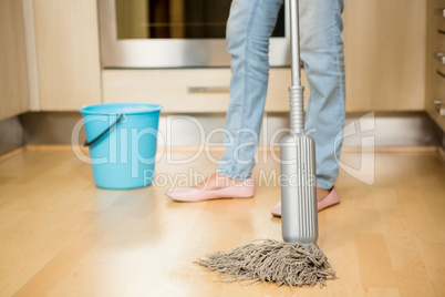 Woman cleaning the floor with mop