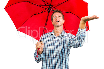 Man checking weather while holding red umbrella