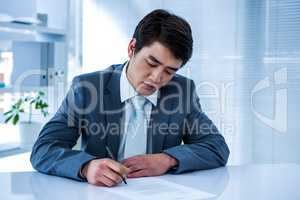 Focused businessman signing contract