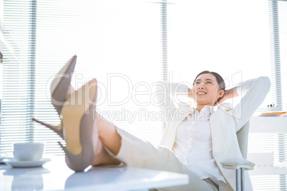 Relaxed businesswoman sitting with her feet up