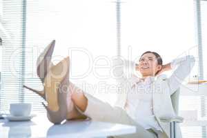 Relaxed businesswoman sitting with her feet up