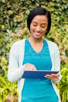 Smiling brunette using tablet