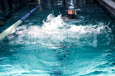 Fit woman swimming with swimming hat