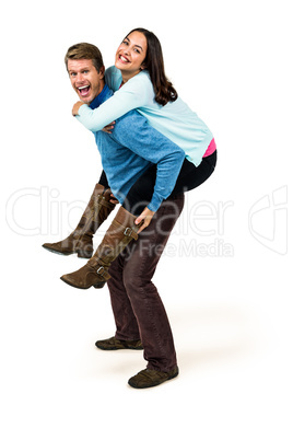 Full length of cheerful man carrying girlfriend on back