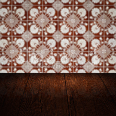 Wood table top and blur vintage ceramic tile pattern wall