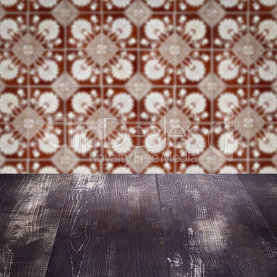 Wood table top and blur vintage ceramic tile pattern wall