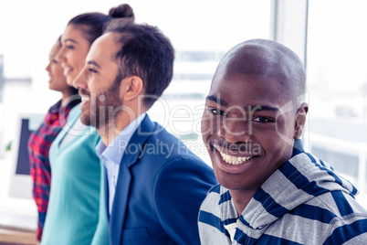 Portrait of happy businessman with colleagues