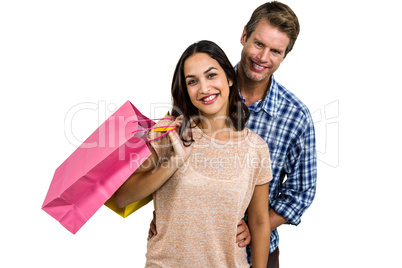 Attractive couple holding shopping bags