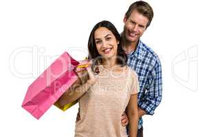 Attractive couple holding shopping bags