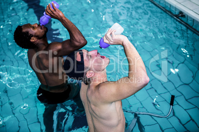 Fit men cycling in the pool