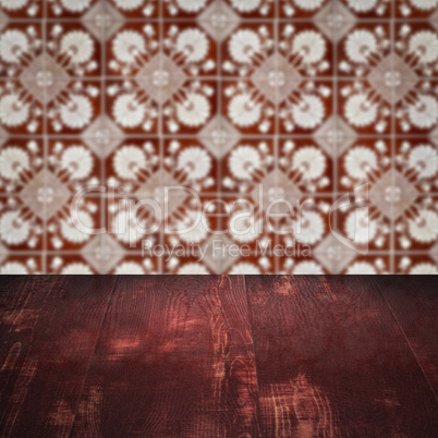 Wood table top and blur vintage ceramic tile pattern wall