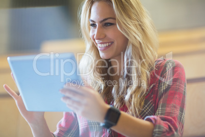 Smiling female student using tablet