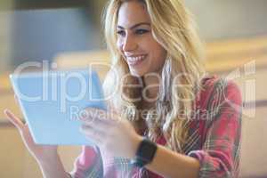 Smiling female student using tablet